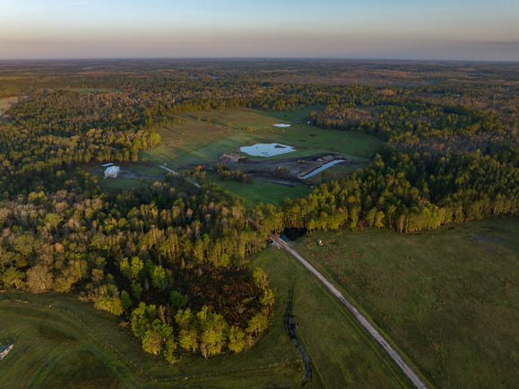 An aerial view of a Florida ranch with fields, trees and ponds