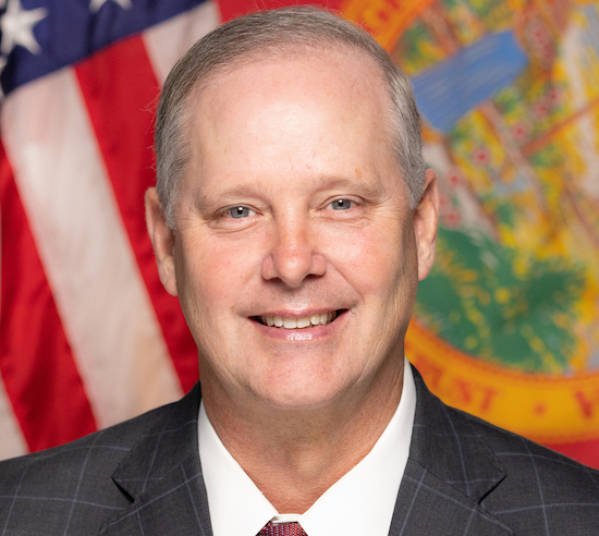 Portrait of Commissioner Wilton Simpson smiling in a suit and tie