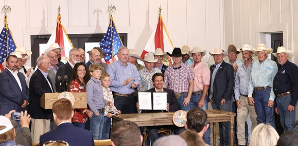 Governor Ron DeSantis with Commissioner Wilton Simpson and Florida farmers following the signing of the 2025 Florida Farm Bill