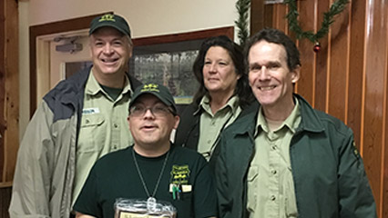 A group of smiling Florida Forest Service employees and volunteers