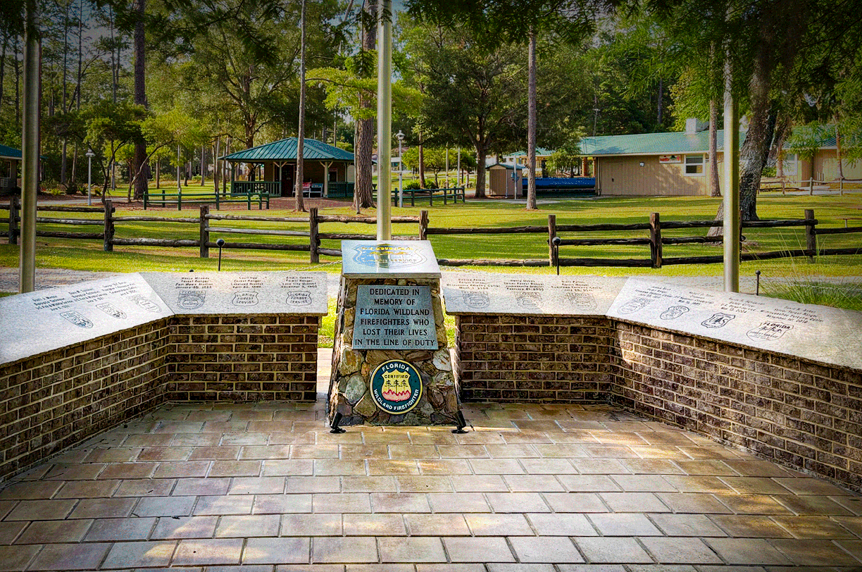 A stone and brick memorial dedicated to firefighters who lost their lives in the line of duty