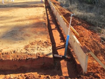 Termite treatment around the foundation of a house under construction