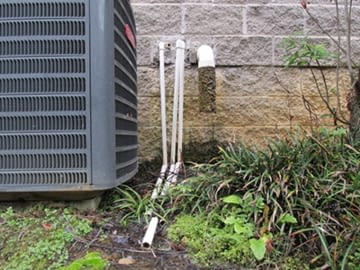 A pipe draining near the foundation of a home
