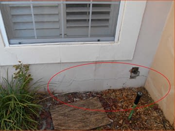 A sprinkler next to a house