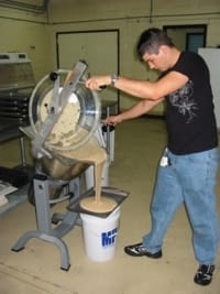 A man in a laboratory preparing food for Argentine cactus moth larvae