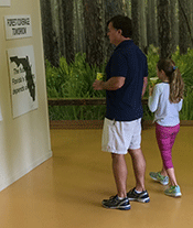 Father and Daughter Looking at a Display