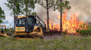 Photo: Medium dozer pulling a fireline plow.